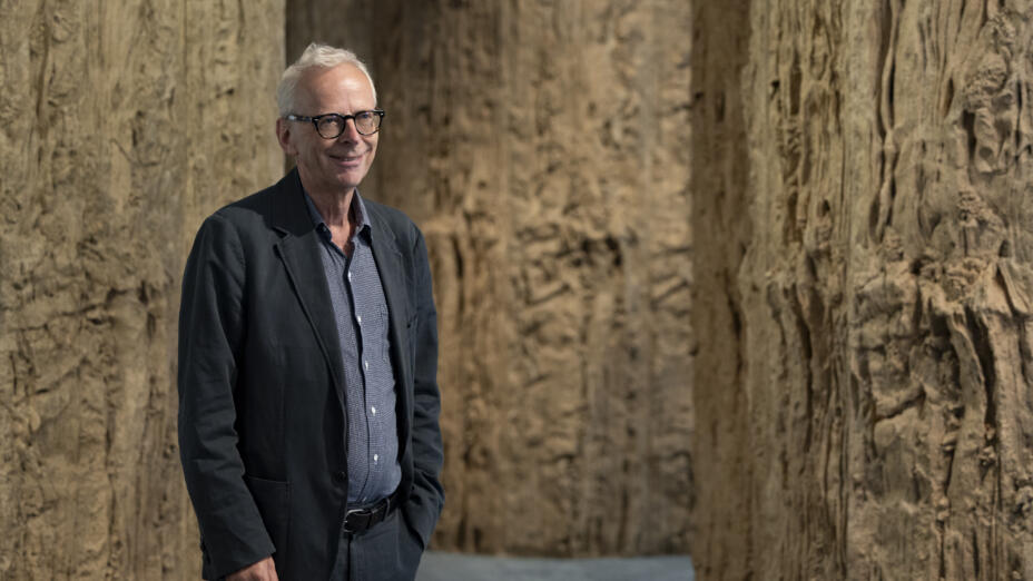 Our Chair, James Lingwood, standing in front of sculptures at an exhibition in Barcelona.