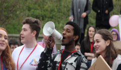 Image shows a boy from the British Youth Council speaking through a megaphone