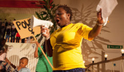 Praxis Community Projects supports migrant communities to make their voices heard - image shows a woman with a megaphone